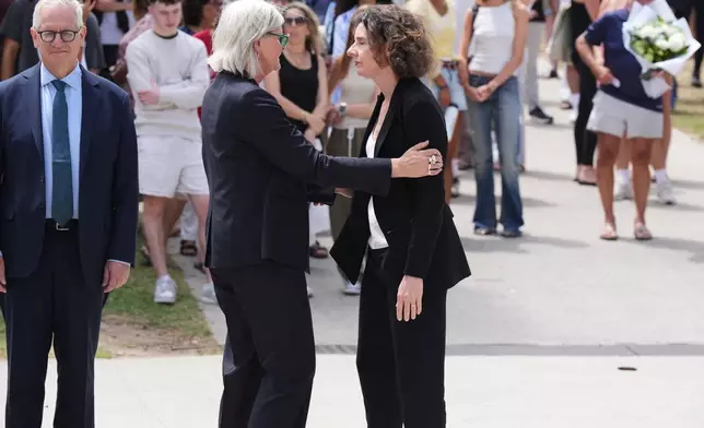 Governor General Sam Mostyn, left, greets MP, Allegra Spender, at a gathering at a flower memorial to shooting victims outside the Bondi Pavilion at Sydney's Bondi Beach, Monday, Dec. 15, 2025, a day after a shooting. (AP Photo/Mark Baker)