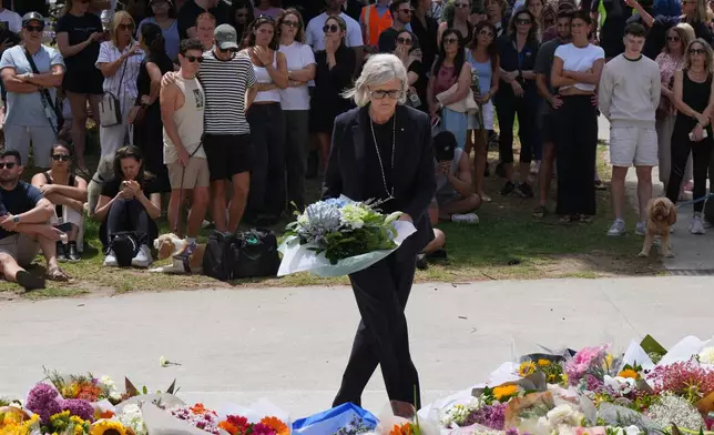 Governor General Sam Mostyn places flowers at a tribute to shooting victims outside the Bondi Pavilion at Sydney's Bondi Beach, Monday, Dec. 15, 2025, a day after a shooting. (AP Photo/Mark Baker)