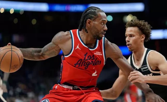 Los Angeles Clippers forward Kawhi Leonard (2) drives against Atlanta Hawks guard Dyson Daniels (5) during the first half of an NBA basketball game, Wednesday, Dec. 3, 2025, in Atlanta. (AP Photo/Mike Stewart)