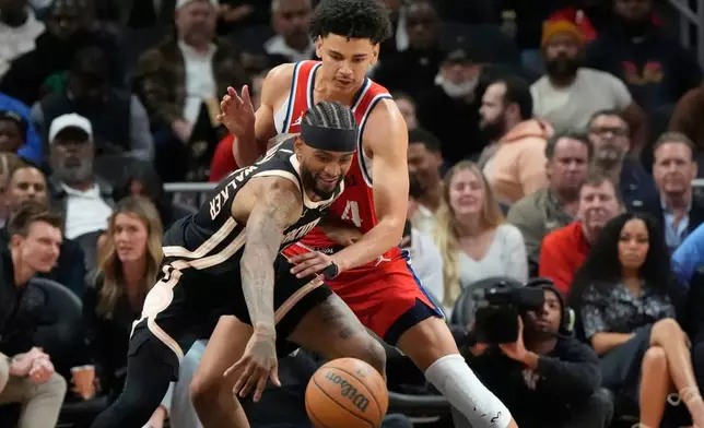 Atlanta Hawks guard Nickeil Alexander-Walker (7) drives against Los Angeles Clippers guard Kobe Sanders (4) during the first half of an NBA basketball game, Wednesday, Dec. 3, 2025, in Atlanta. (AP Photo/Mike Stewart)