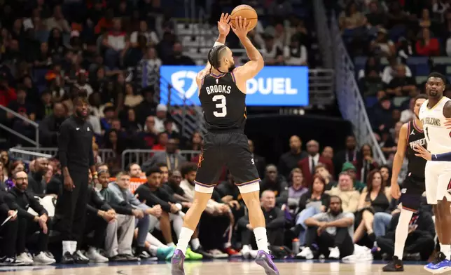 Phoenix Suns forward Dillon Brooks (3) shoots a 3-point basket in the first half of an NBA basketball game against the New Orleans Pelicans, Friday, Dec. 26, 2025, in New Orleans. (AP Photo/Peter Forest)