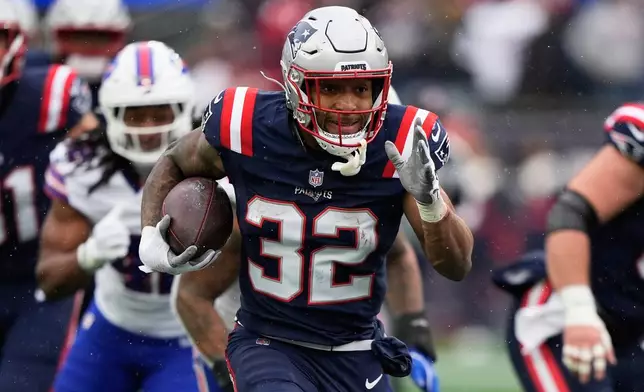 New England Patriots running back Treveyon Henderson (32) runs toward the end zone to score against the Buffalo Bills during the first half of an NFL football game in Foxborough, Mass., Sunday, Dec. 14, 2025. (AP Photo/Robert F. Bukaty)
