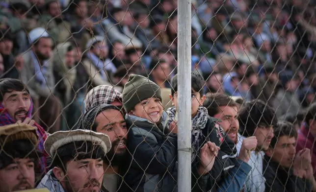 Afghan men and boys attend the final of Afghanistan's annual buzkashi tournament, a traditional equestrian sport in which riders compete to score points using a fake goat carcass, on the outskirts of Kabul, Afghanistan, Monday, Dec. 22, 2025. (AP Photo)