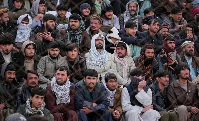 Afghan men attend the final of Afghanistan's annual buzkashi tournament, a traditional equestrian sport in which riders compete to score points using a fake goat carcass, on the outskirts of Kabul, Afghanistan, Monday, Dec. 22, 2025. (AP Photo)