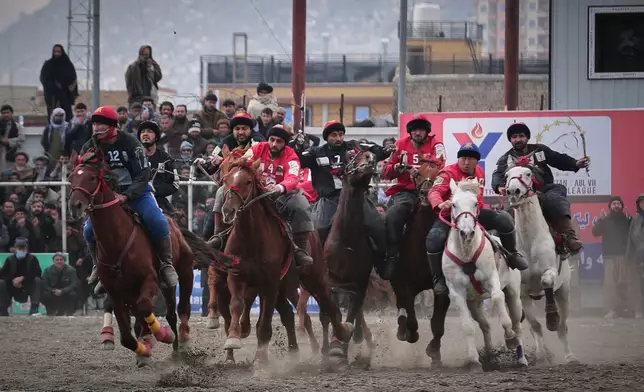 Riders from the Sar-e-Pul and Badakhshan compete in the final of Afghanistan's annual buzkashi tournament, a traditional equestrian sport in which riders score points using a fake goat carcass, on the outskirts of Kabul, Afghanistan, Monday, Dec. 22, 2025. (AP Photo)
