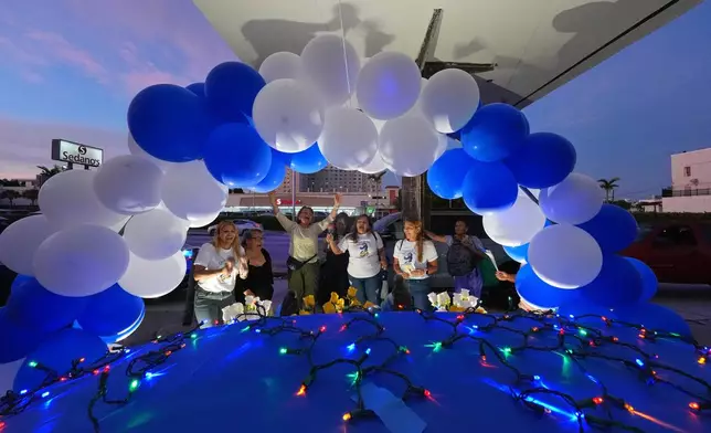 Nicaraguans sing in praise of the Virgin Mary at one of dozens of open-air altars set up near St. John Bosco Catholic Church in celebration of the Dec. 8 feast of the Immaculate Conception, Sunday, Dec. 7, 2025, in Miami. (AP Photo/Rebecca Blackwell)