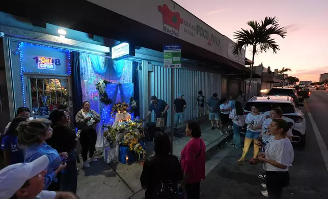 Nicaraguans sing in praise of the Virgin Mary at one of dozens of open-air altars set up near St. John Bosco Catholic Church in celebration of the Dec. 8 feast of the Immaculate Conception, Sunday, Dec. 7, 2025, in Miami. (AP Photo/Rebecca Blackwell)