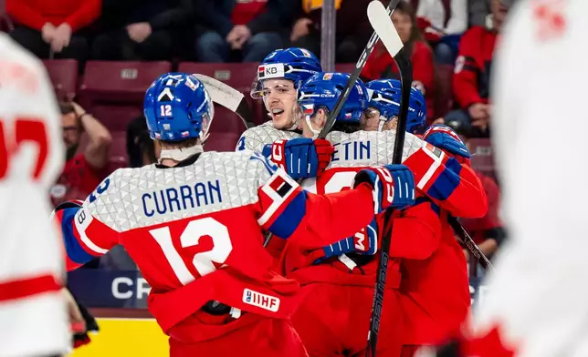 Czechia's Tomas Poletin (18), center, celebrates his goal with teammates during the first period of an IIHF World Junior Hockey Championship game against Canada in Minneapolis, Friday, Dec. 26, 2025. (Christopher Katsarov/The Canadian Press via AP)