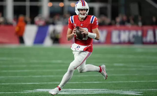 New England Patriots quarterback Drake Maye rolls out during the first half of an NFL football game against the New York Giants, Monday, Dec. 1, 2025, in Foxborough, Mass. (AP Photo/Charles Krupa)