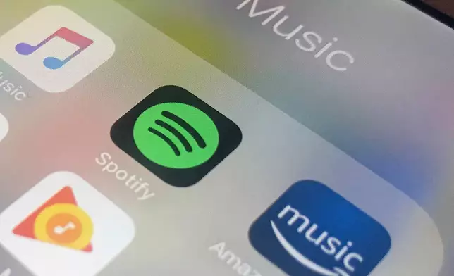 FILE - This Sunday, Jan. 28, 2018, photo shows music streaming apps clockwise from top left, Apple, Spotify, Amazon, Pandora and Google on an iPhone in New York. (AP Photo/Jenny Kane, File)