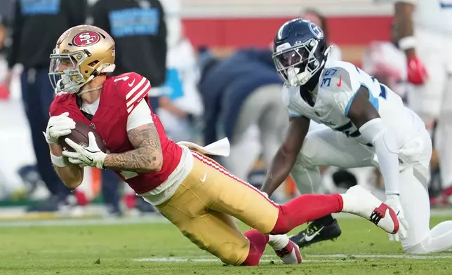 San Francisco 49ers wide receiver Ricky Pearsall (1) makes a catch past Tennessee Titans cornerback Kaiir Elam (35) during the second half of an NFL football game, Sunday, Dec. 14, 2025, in Santa Clara, Calif. (AP Photo/Godofredo A. Vásquez)