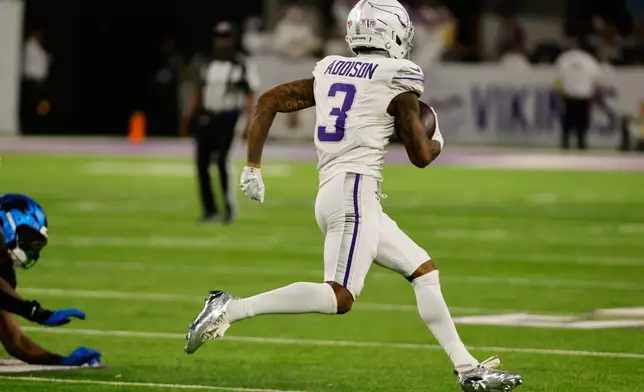 Minnesota Vikings wide receiver Jordan Addison runs to score a touchdown during the second half of an NFL football game against the Detroit Lions, Thursday, Dec. 25, 2025, in Minneapolis. (AP Photo/Bruce Kluckhohn)