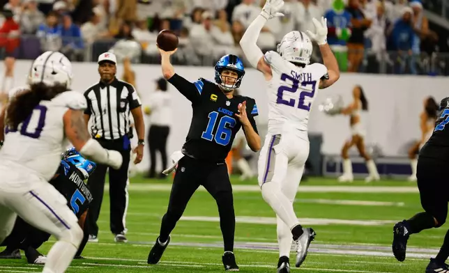 Detroit Lions quarterback Jared Goff (16) throws under pressure from Minnesota Vikings safety Harrison Smith (22) during the second half of an NFL football game, Thursday, Dec. 25, 2025, in Minneapolis. (AP Photo/Bruce Kluckhohn)