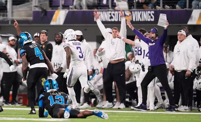 Minnesota Vikings wide receiver Jordan Addison (3) runs past Detroit Lions cornerback D.J. Reed (4), and safety Jalen Mills to score a touchdown during the second half of an NFL football game, Thursday, Dec. 25, 2025, in Minneapolis. (AP Photo/Abbie Parr)