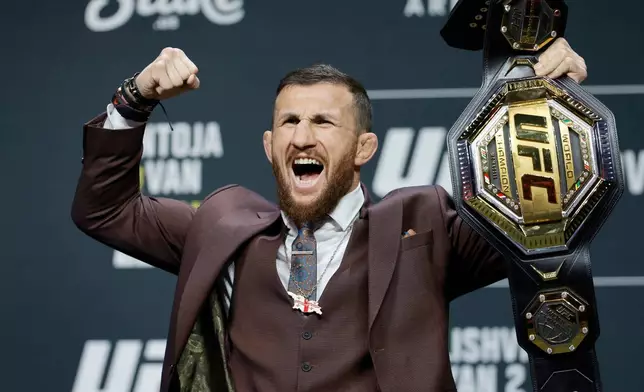 UFC bantamweight champion Merab Dvalishvili, of Georgia, poses with his title belt during a news conference promoting UFC 323, Thursday, Dec. 4, 2025, in Las Vegas. (Steve Marcus/Las Vegas Sun via AP)