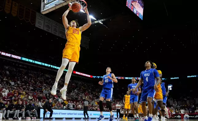 Iowa State forward Blake Buchanan (23) dunks the ball over Eastern Illinois forward Kooper Jacobi (40) and guard Andre Washington (4) during the first half of an NCAA college basketball game, Sunday, Dec. 14, 2025, in Ames, Iowa. (AP Photo/Charlie Neibergall)