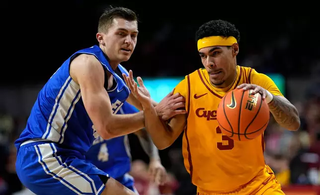Iowa State guard Tamin Lipsey (3) drives past Eastern Illinois forward Kooper Jacobi (40) during the first half of an NCAA college basketball game, Sunday, Dec. 14, 2025, in Ames, Iowa. (AP Photo/Charlie Neibergall)