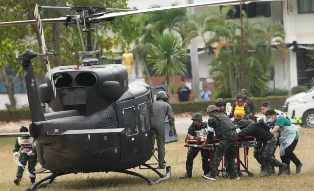An wounded Thai soldier is carried to be transferred to a hospital, in Surin province, Thailand, Wednesday, Dec. 10, 2025, following clashes between Thai and Cambodian soldiers. (AP Photo/Sakchai Lalit)