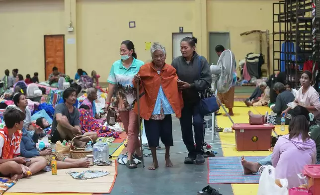 Thai residents who fled homes following the clashes between Thai and Cambodian soldiers, rest at an evacuation center in Surin province, Thailand, Wednesday, Dec. 10, 2025. (AP Photo/Sakchai Lalit)