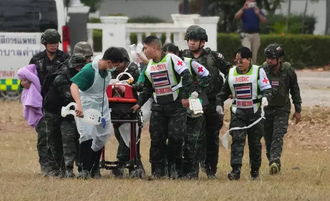 An wounded Thai soldier is carried to be transferred to a hospital, in Surin province, Thailand, Wednesday, Dec. 10, 2025, following clashes between Thai and Cambodian soldiers. (AP Photo/Sakchai Lalit)