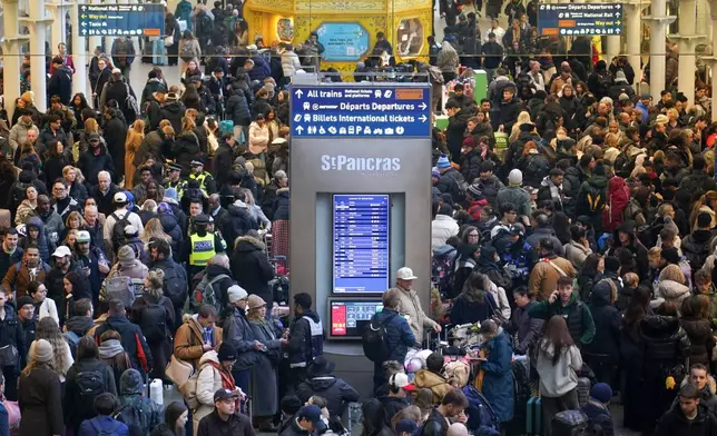 Travelers queue for Eurostar services at St Pancras International station in London, Tuesday, Dec. 30, 2025. (AP Photo/Alberto Pezzali)