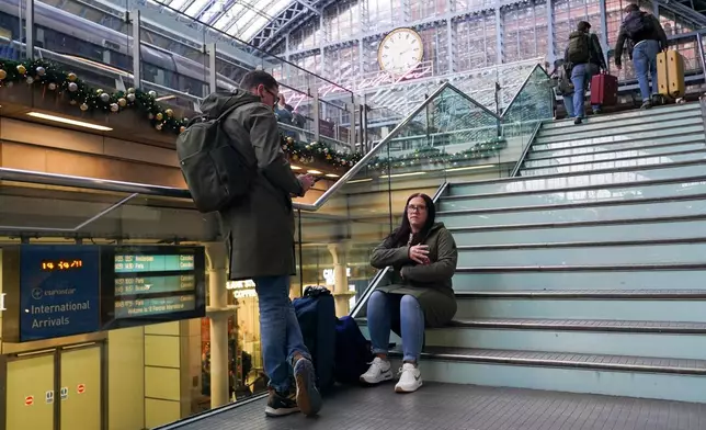Travellers wait for Eurostar services at St Pancras International station in London, Tuesday, Dec. 30, 2025. (AP Photo/Alberto Pezzali)