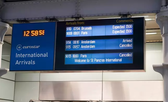 The screen board displays the trains' arrival status at St Pancras International train station in London, Tuesday, Dec. 30, 2025 after Eurostar asked train customers not to travel because of disruption in the Channel Tunnel. (AP Photo/Alberto Pezzali)