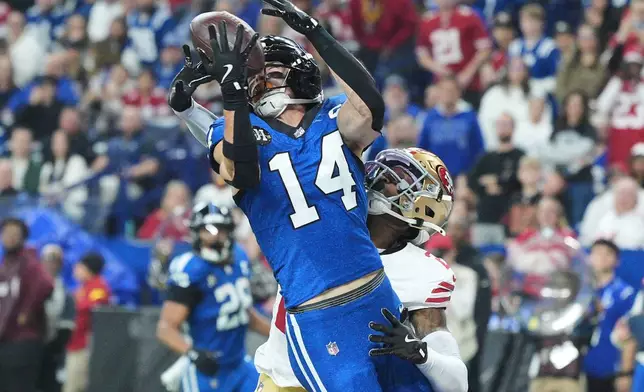 Indianapolis Colts wide receiver Alec Pierce (14) catches a touchdown pass against San Francisco 49ers cornerback Darrell Luter Jr. during the first half of an NFL football game, Monday, Dec. 22, 2025, in Indianapolis. (AP Photo/AJ Mast)
