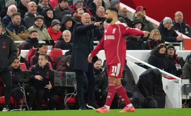 Liverpool's Mohamed Salah, right, and manager Arne Slot gesture during the English Premier League soccer match between Liverpool and Sunderland in Liverpool, Wednesday, Dec. 3, 2025. (AP Photo/Jon Super)