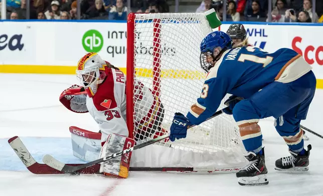 Ottawa Charge goaltender Gwyneth Philips (33) stops Vancouver Goldeneyes' Tereza Vanisova (13) during the third period of a PWHL hockey game in Vancouver, British Columbia, Tuesday, Dec. 16, 2025. (Ethan Cairns/The Canadian Press via AP)