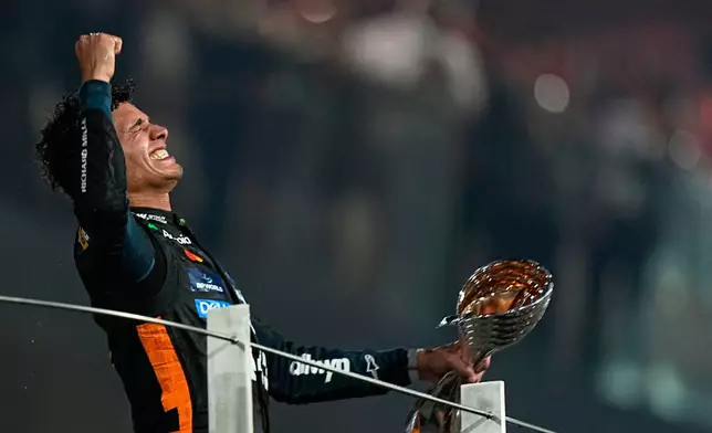 McLaren driver Lando Norris of Britain celebrates after becoming a world champion after the Formula One Abu Dhabi Grand Prix at the Yas Marina Circuit in Abu Dhabi, UAE, Sunday, Dec. 7, 2025. (AP Photo/Fatima Shbair)