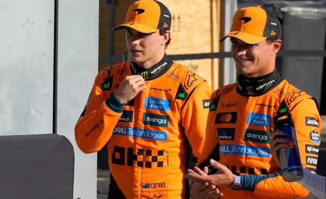 FILE -McLaren driver Oscar Piastri of Australia, left, and McLaren driver Lando Norris of Britain walk through the paddock after the qualifying session ahead of the Italian Grand Prix at the Monza racetrack in Monza, Italy, Saturday, Sept. 6, 2025. (AP Photo/Luca Bruno, File)