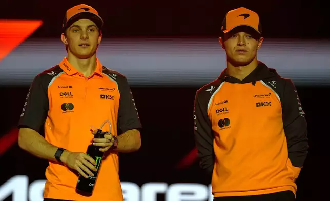 FILE - McLaren driver Lando Norris of Britain, right, and McLaren driver Oscar Piastri of Australia during the driver's parade at the Qatar Formula One Grand Prix, in Lusail, Qatar, Sunday, Nov. 30, 2025.(AP Photo/Altaf Qadri, File)