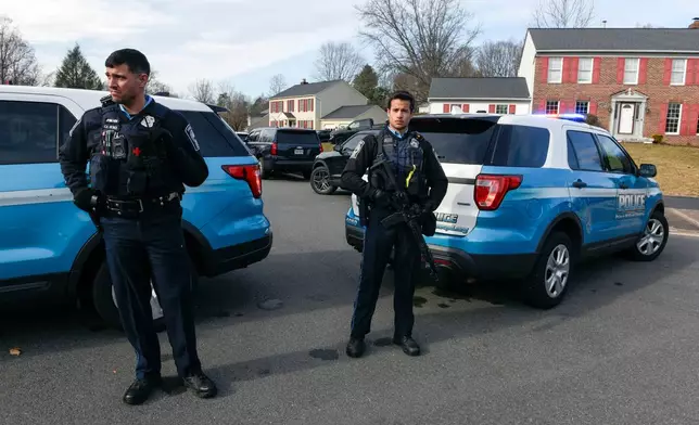 Prince William County Police block the street near the house where the FBI made an arrest, in Woodbridge, Va., Thursday, Dec. 4, 2025, in a nearly five-year old investigation into who placed pipe bombs in Washington before the Jan. 6, 2021 riot at the US Capitol. (AP Photo/Cliff Owen)