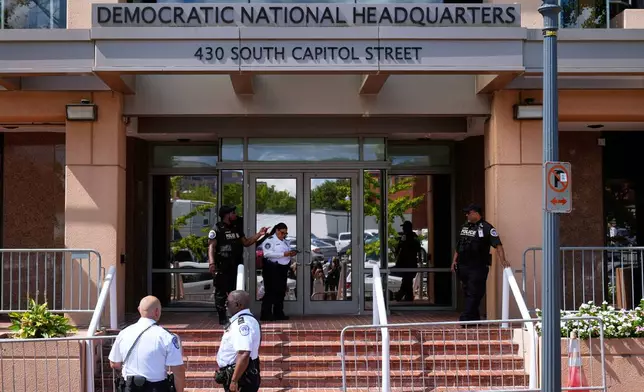 FILE - Members of law enforcement are pictured outside Democratic National Committee headquarters, Sept. 11, 2025, in Washington. (AP Photo/Mark Schiefelbein, File)