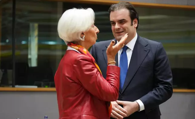 European Central Bank President Christine Lagarde, left, speaks with Greece's Finance Minister Kyriakos Pierrakakis during a meeting of eurozone finance ministers at the EU Council building in Brussels, Thursday, Dec. 11, 2025. (AP Photo/Virginia Mayo)
