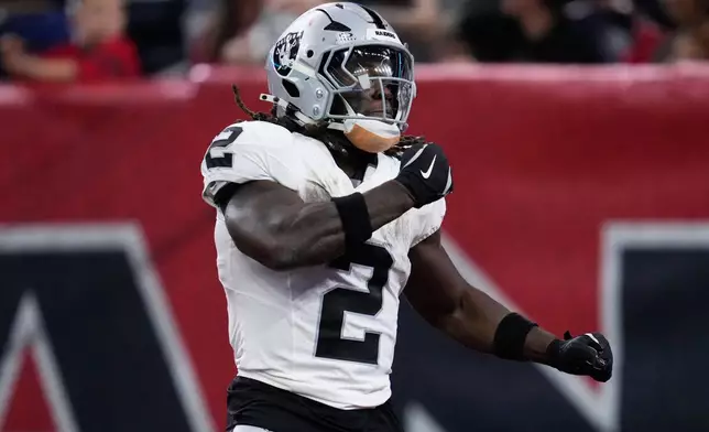 Las Vegas Raiders running back Ashton Jeanty (2) celebrates after scoring against the Houston Texans during the second half of an NFL football game, Sunday, Dec. 21, 2025, in Houston. (AP Photo/Ashley Landis)