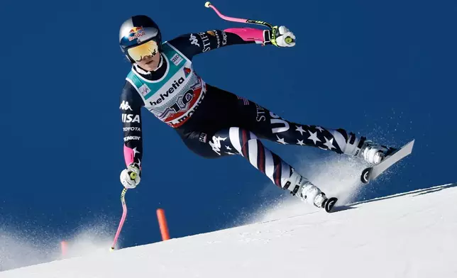 United States' Lindsey Vonn speeds down the course during an alpine ski, women's World Cup super-G event, in St. Moritz, Switzerland, Sunday Dec. 14, 2025. (AP Photo/Gabriele Facciotti)