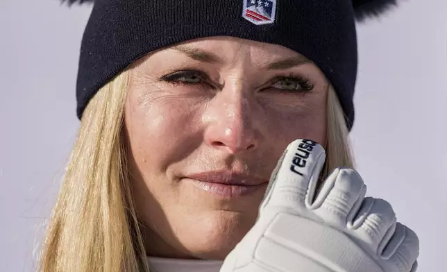 United States' Lindsey Vonn gets emotional as she celebrates winning an alpine ski, women's World Cup downhill, in St. Moritz, Switzerland, Friday Dec. 12, 2025. (Claudio Thoma/Keystone via AP)