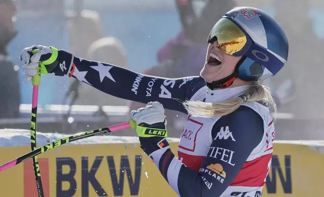 United States' Lindsey Vonn celebrates at the finish area of an alpine ski, women's World Cup downhill in St. Moritz, Switzerland, Friday Dec.12, 2025. (AP Photo/Luciano Bisi)