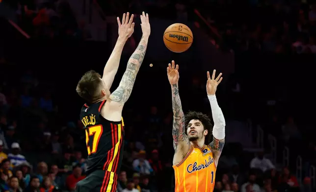 Charlotte Hornets guard LaMelo Ball (1) shoots against Atlanta Hawks guard Vit Krejci, left, during the first half of an NBA basketball game in Charlotte, N.C., Thursday, Dec. 18, 2025. (AP Photo/Nell Redmond)