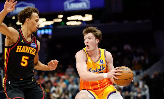 Charlotte Hornets guard Kon Knueppel, right, looks to drive against Atlanta Hawks guard Dyson Daniels (5) during the first half of an NBA basketball game in Charlotte, N.C., Thursday, Dec. 18, 2025. (AP Photo/Nell Redmond)