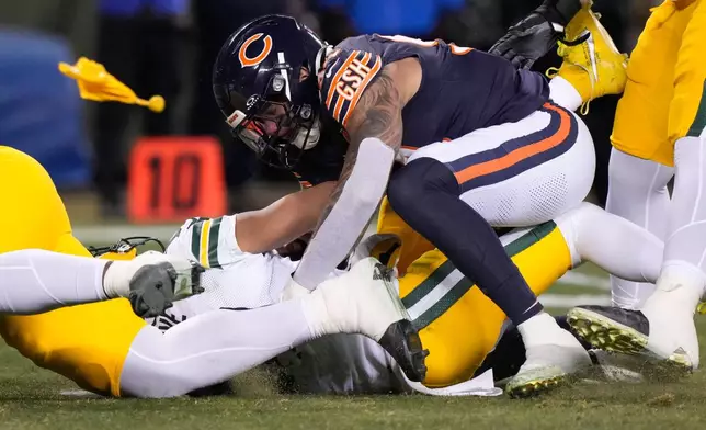 Green Bay Packers' Jordan Love is hurt as he is hit by Chicago Bears' Austin Booker during the first half of an NFL football game Saturday, Dec. 20, 2025, in Chicago. (AP Photo/Nam Huh)