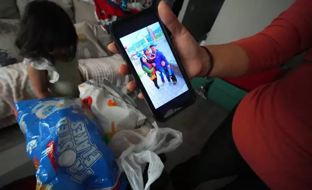 Cristina Osornio shows a photo, Nov. 18, 2025, in Rogers, Ark., from a recent trip to San Luis Potosi, Mexico, where she took her two daughter to see her husband, Edwin Sanchez-Mendoza, who signed deportation papers after being held in an immigration detention center for several months. (AP Photo/Julio Cortez)