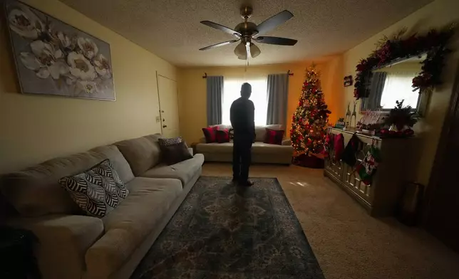 Ernesto, an immigrant from Venezuela, poses for a photograph in his home, Nov. 18, 2025, in Fayetteville, Ark. (AP Photo/Julio Cortez)
