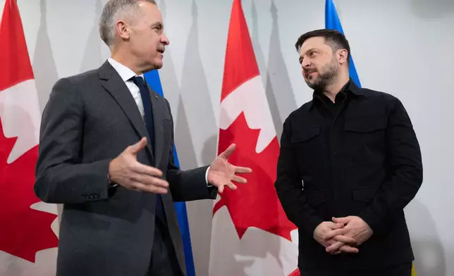 Prime Minister Mark Carney, left, and Ukrainian President Volodymyr Zelenskyy hold a news conference in Halifax, N.S. on Saturday, Dec. 27, 2025.(Riley Smith /The Canadian Press via AP)