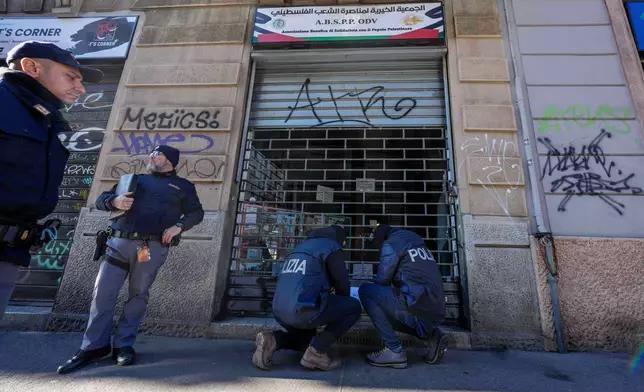 Police officers inspect a charitable association supporting Palestinian civilians in Milan, Italy, Saturday, Dec. 27, 2025 after Italian investigators have arrested nine people suspected of raising millions of euros for Hamas. (Claudio Furlan/LaPresse via AP)