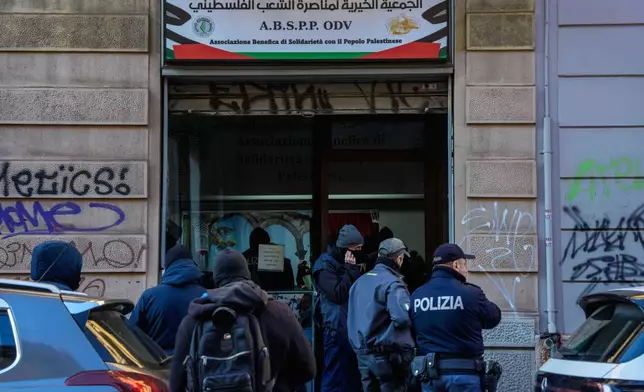Police officers inspect a charitable association supporting Palestinian civilians in Milan, Italy, Saturday, Dec. 27, 2025 after Italian investigators have arrested nine people suspected of raising millions of euros for Hamas. (Claudio Furlan/LaPresse via AP)