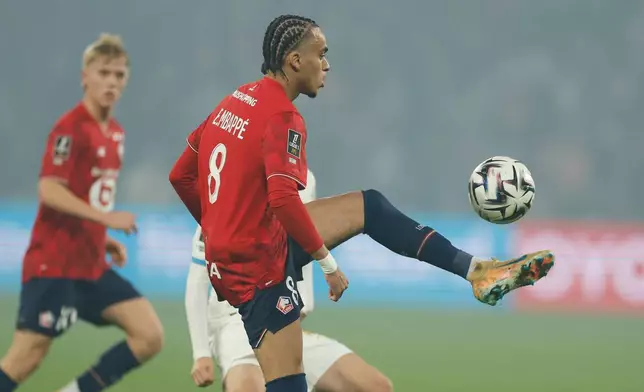 Lille's Ethan Mbappe controls the ball during the French League One soccer match between Lille and Marseille in Villeneuve-d'Ascq, outside Lille, France, Friday, Dec. 5, 2025. (AP Photo/Jean-Francois Badias)