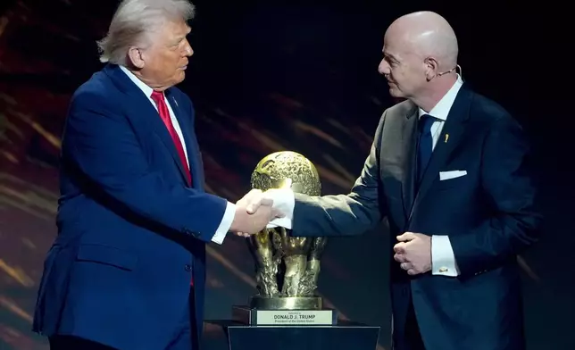 FILE - FIFA President Gianni Infantino, right, awards President Donald Trump with the FIFA Peace Prize during the draw for the 2026 soccer World Cup at the Kennedy Center in Washington, Friday, Dec. 5, 2025. (AP Photo/Chris Carlson, File)